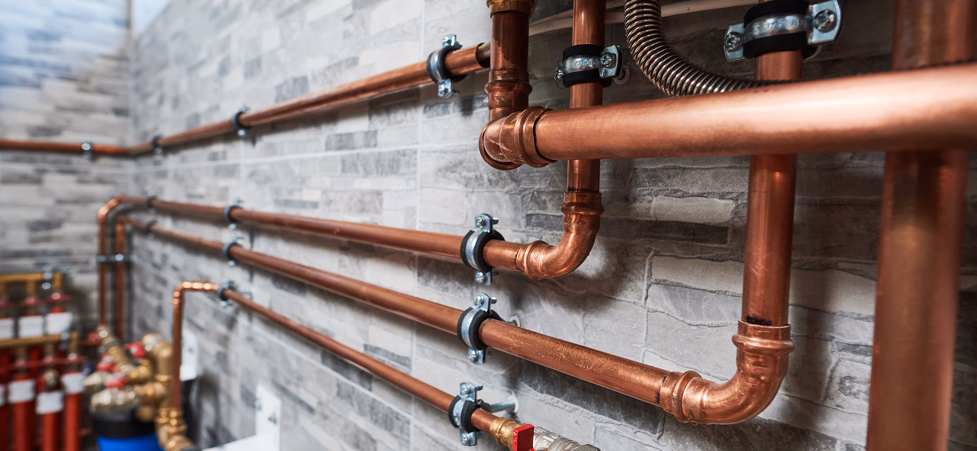 Plumbing pipes and fixtures installed in a home.