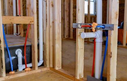 Plumbing rough-ins installed inside a new home build.